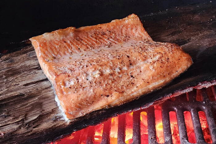 Coho salmon cooked on a grill.